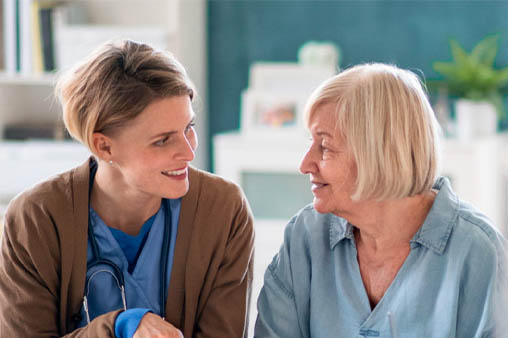 nurse talking to elderly patient