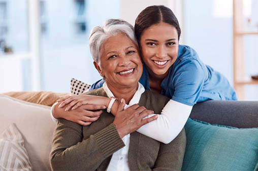 Nurse hugging woman